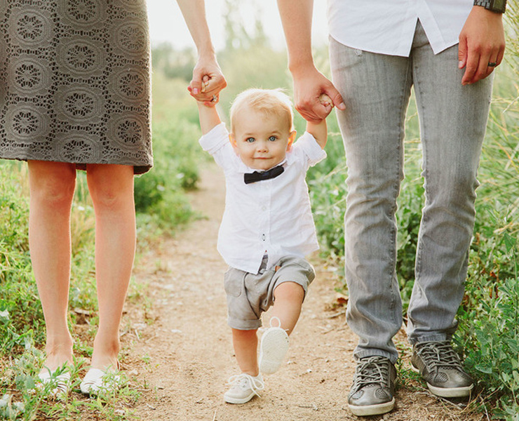 baby in bowtie with mom and dad
