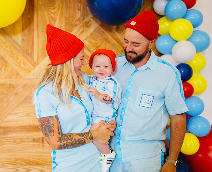 baby mom and dad in red beanies
