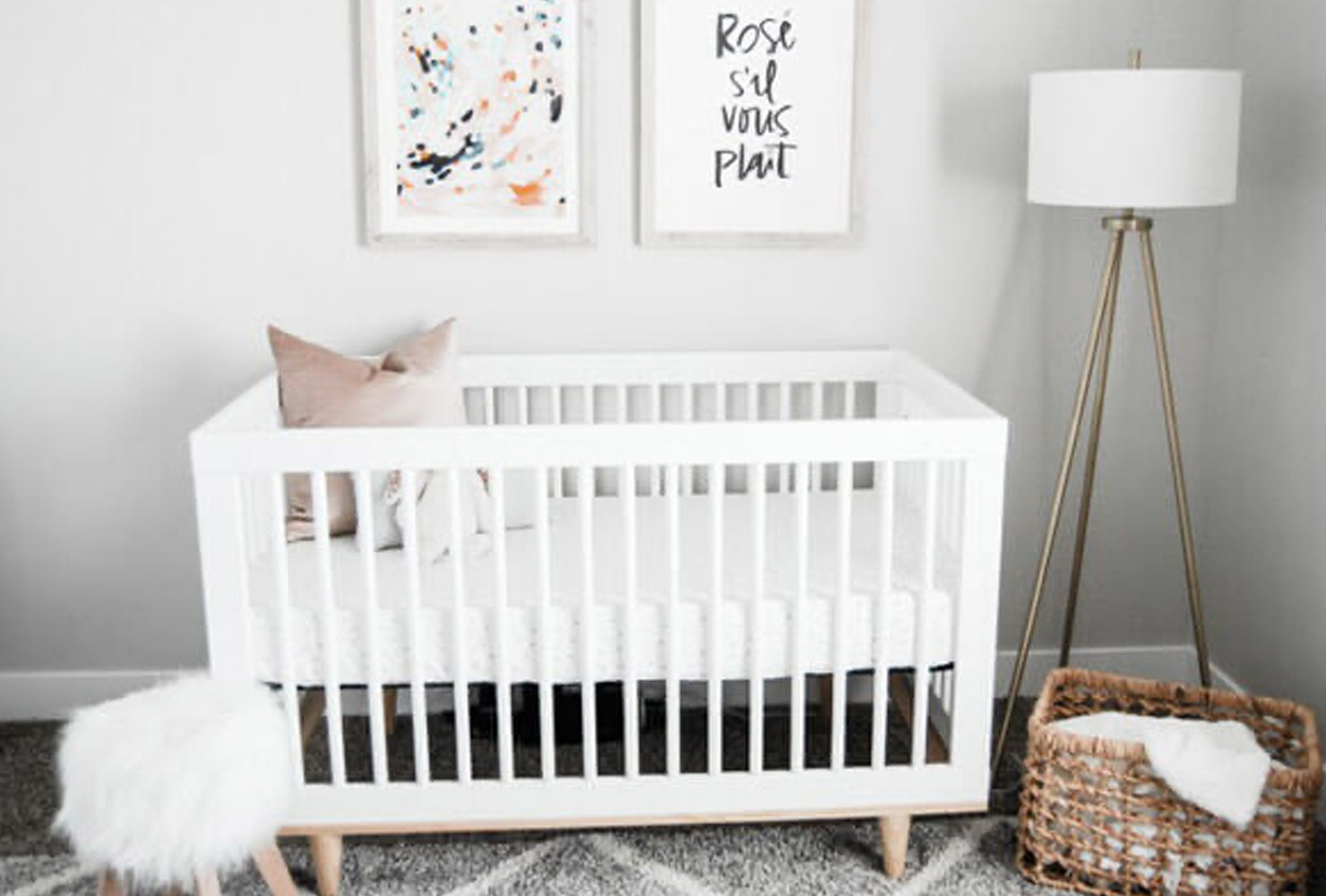 Gray and white nursery decor with crib.