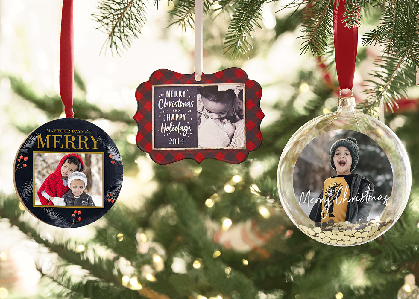Personalized ornaments hanging on a tree.