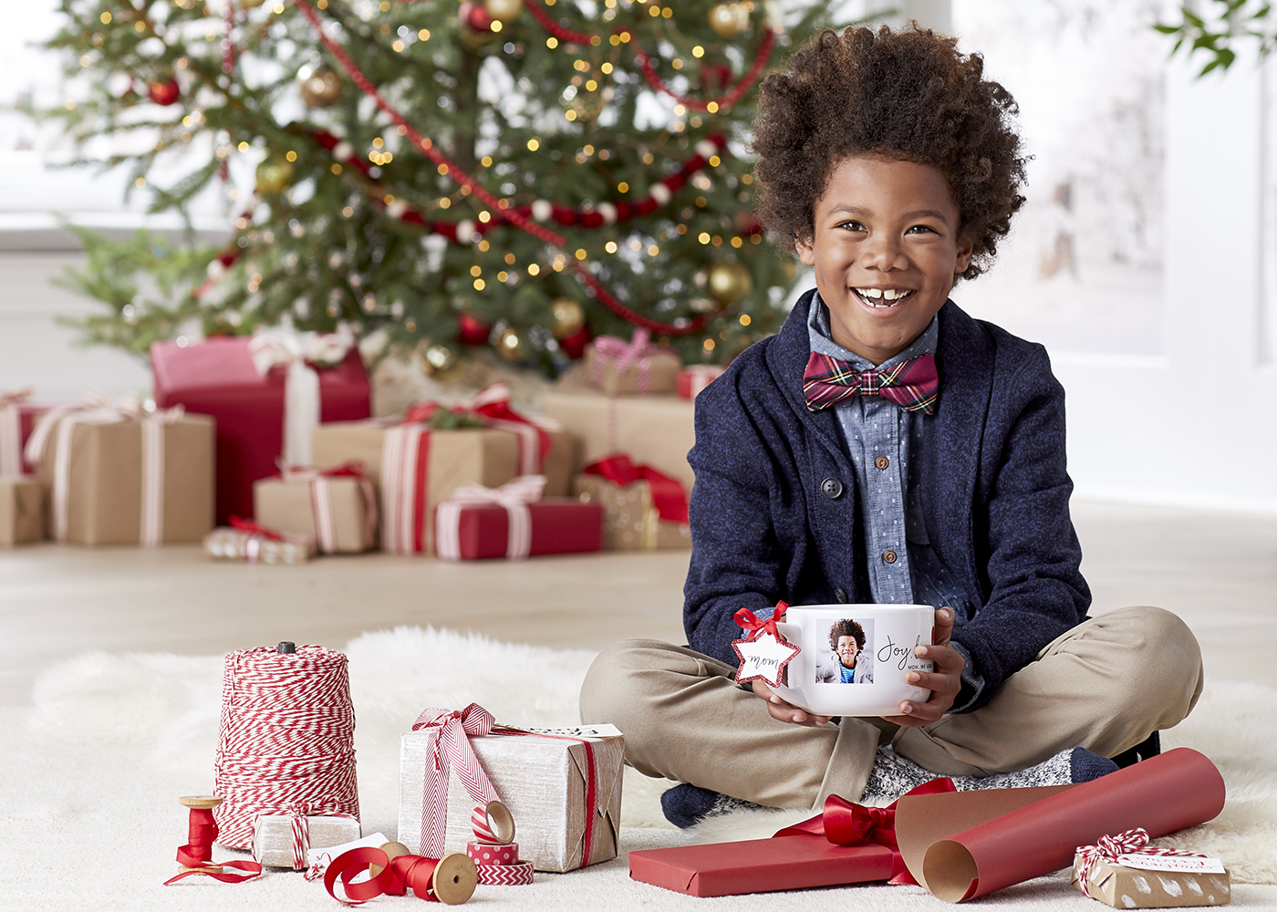 Kid helping with Christmas gift wrapping.