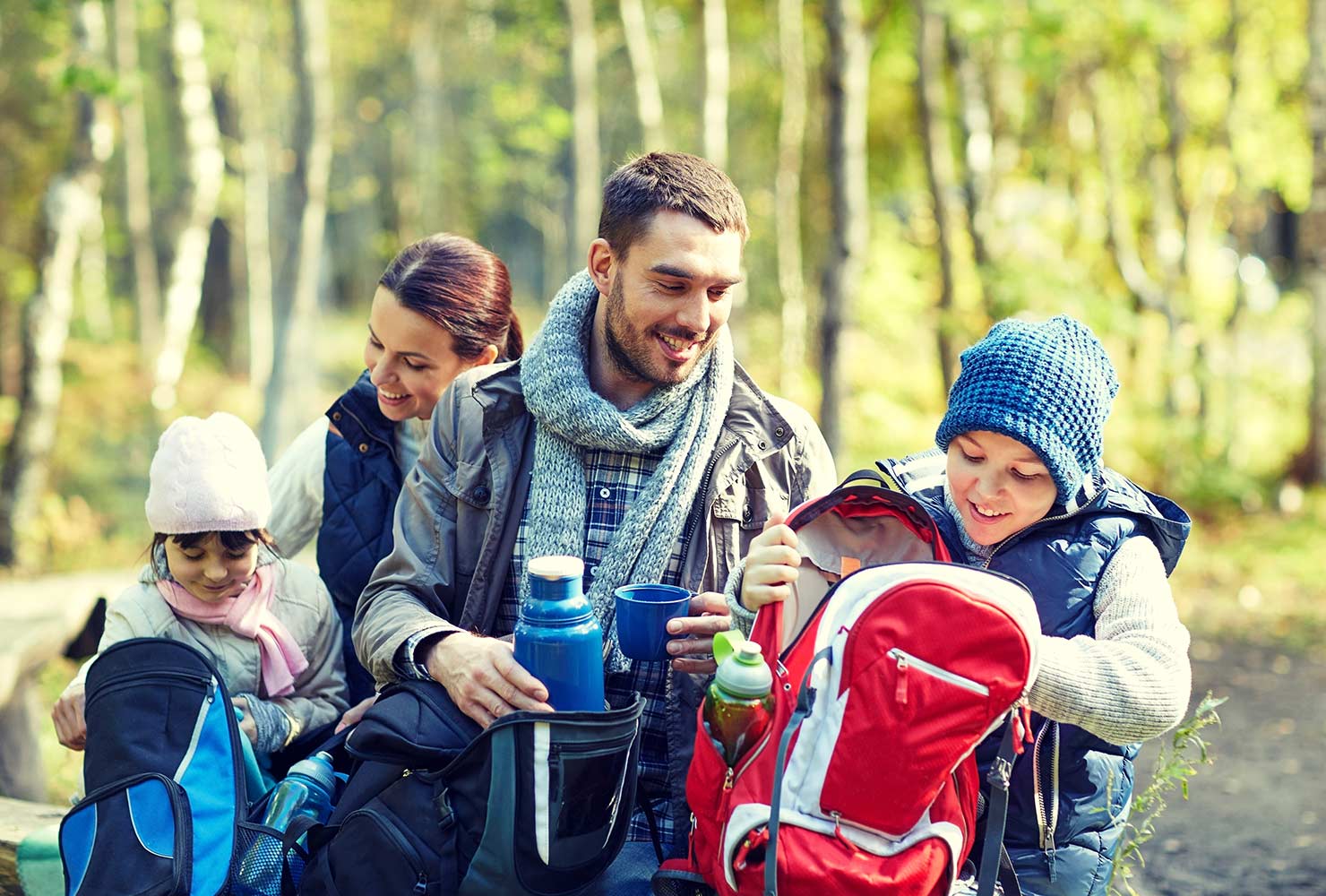 family of four camping in the fall
