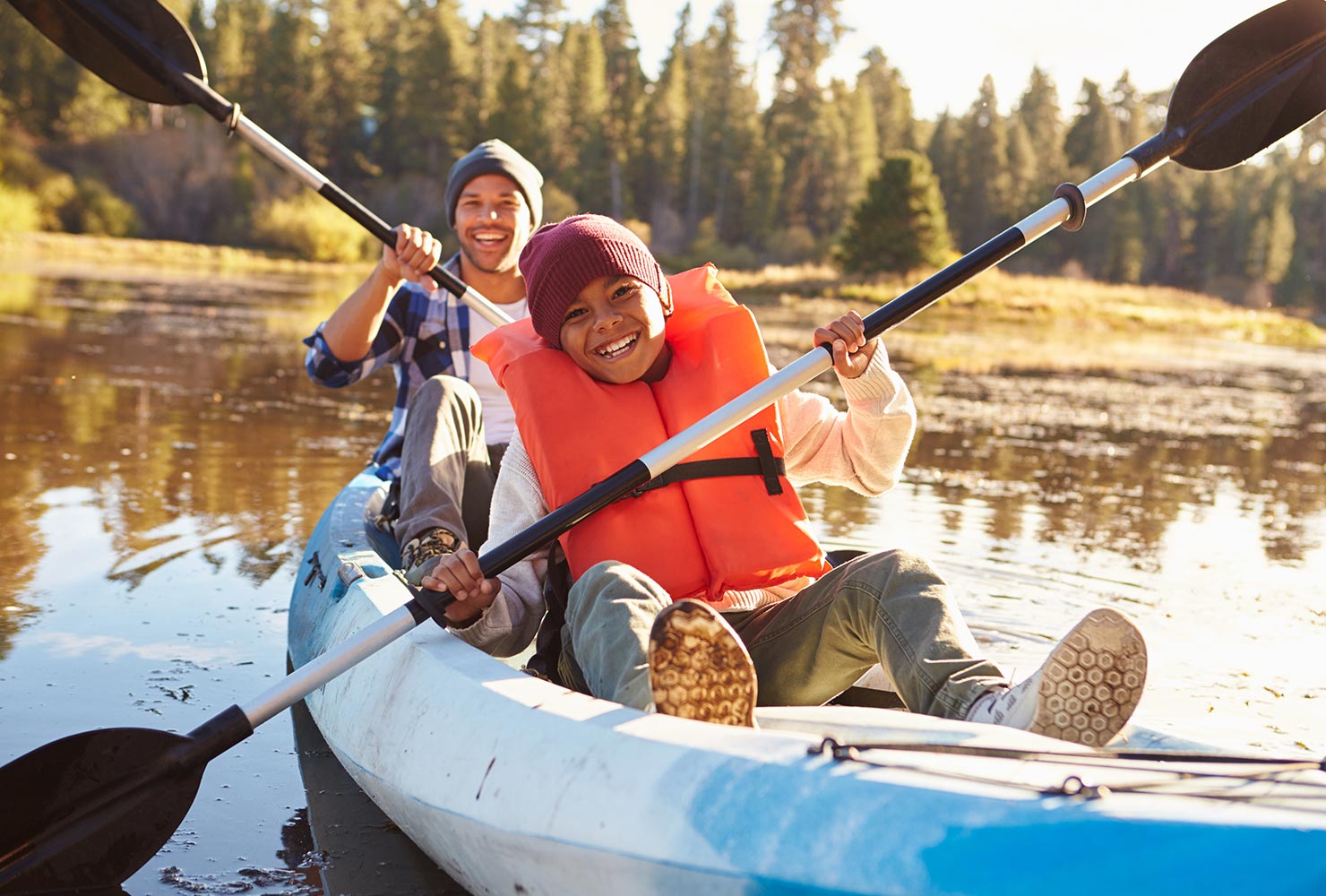 kid and his dad canoeing
