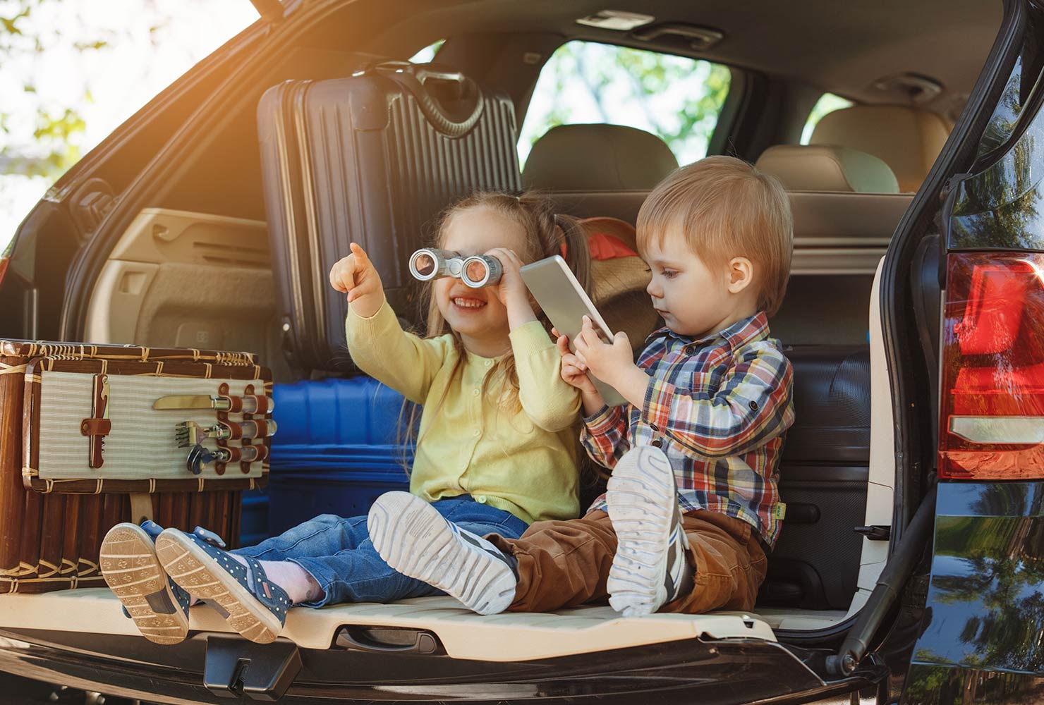 kids in the back of a car on a roadtrip