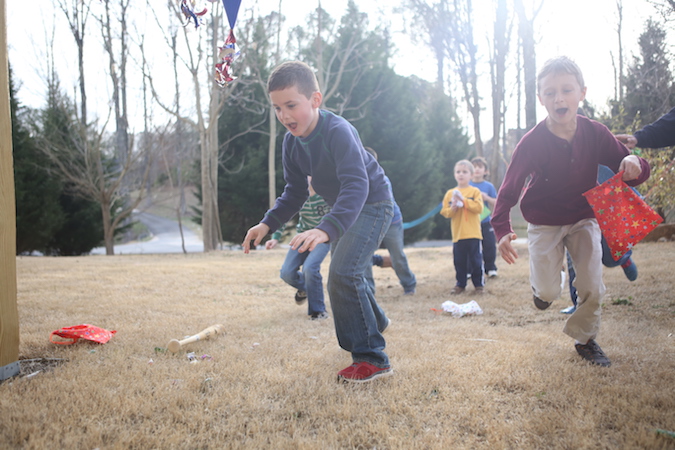 a group of boys playing yard games at a block party