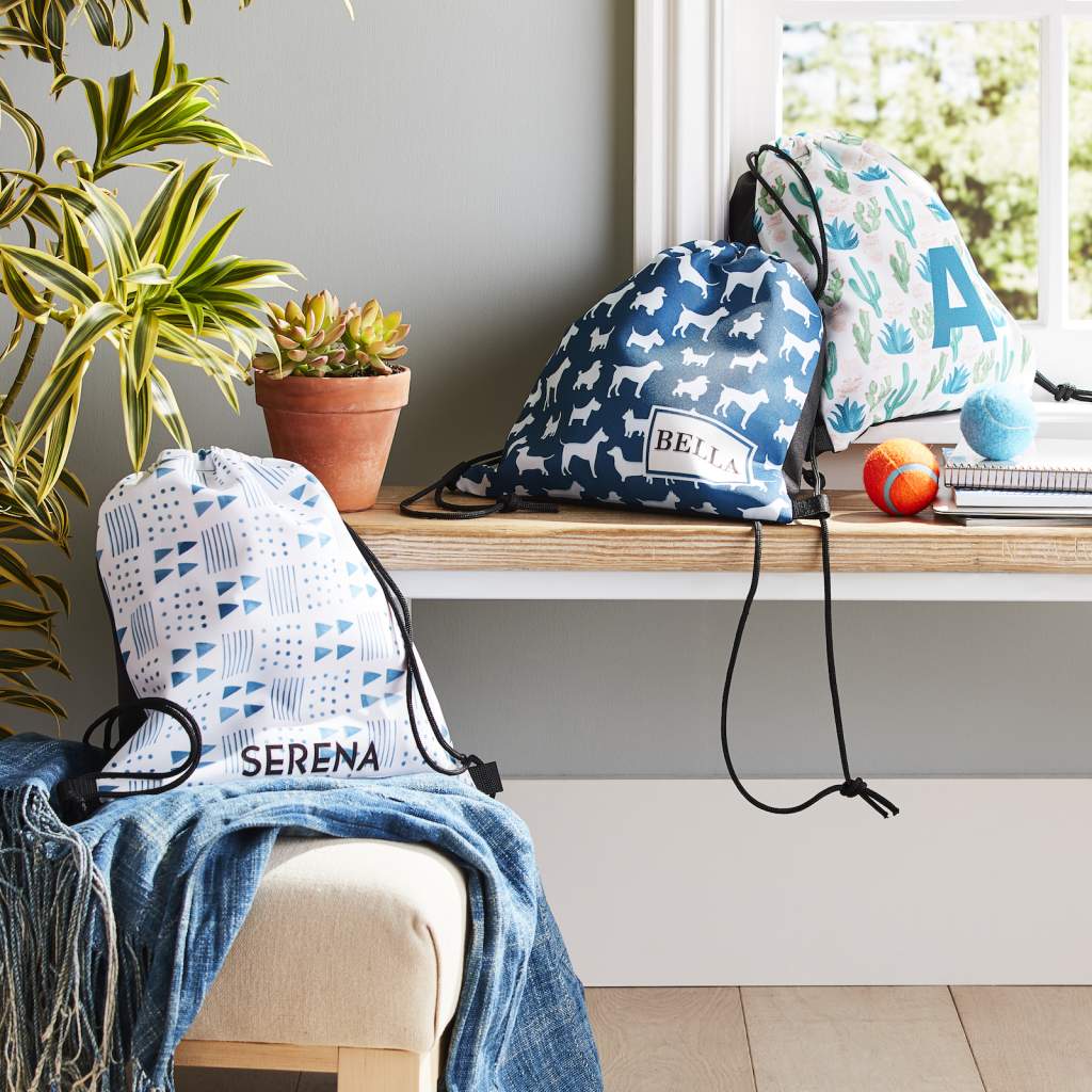 drawstring backpacks displayed in a living room as a party favor