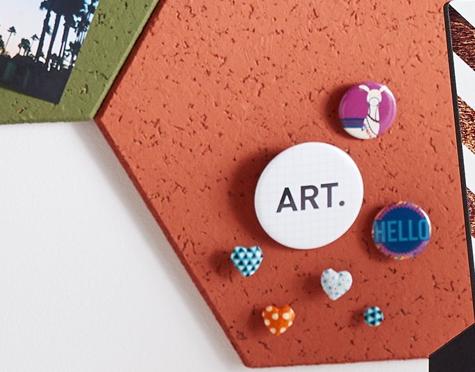 custom pins on a chalkboard for party favors.