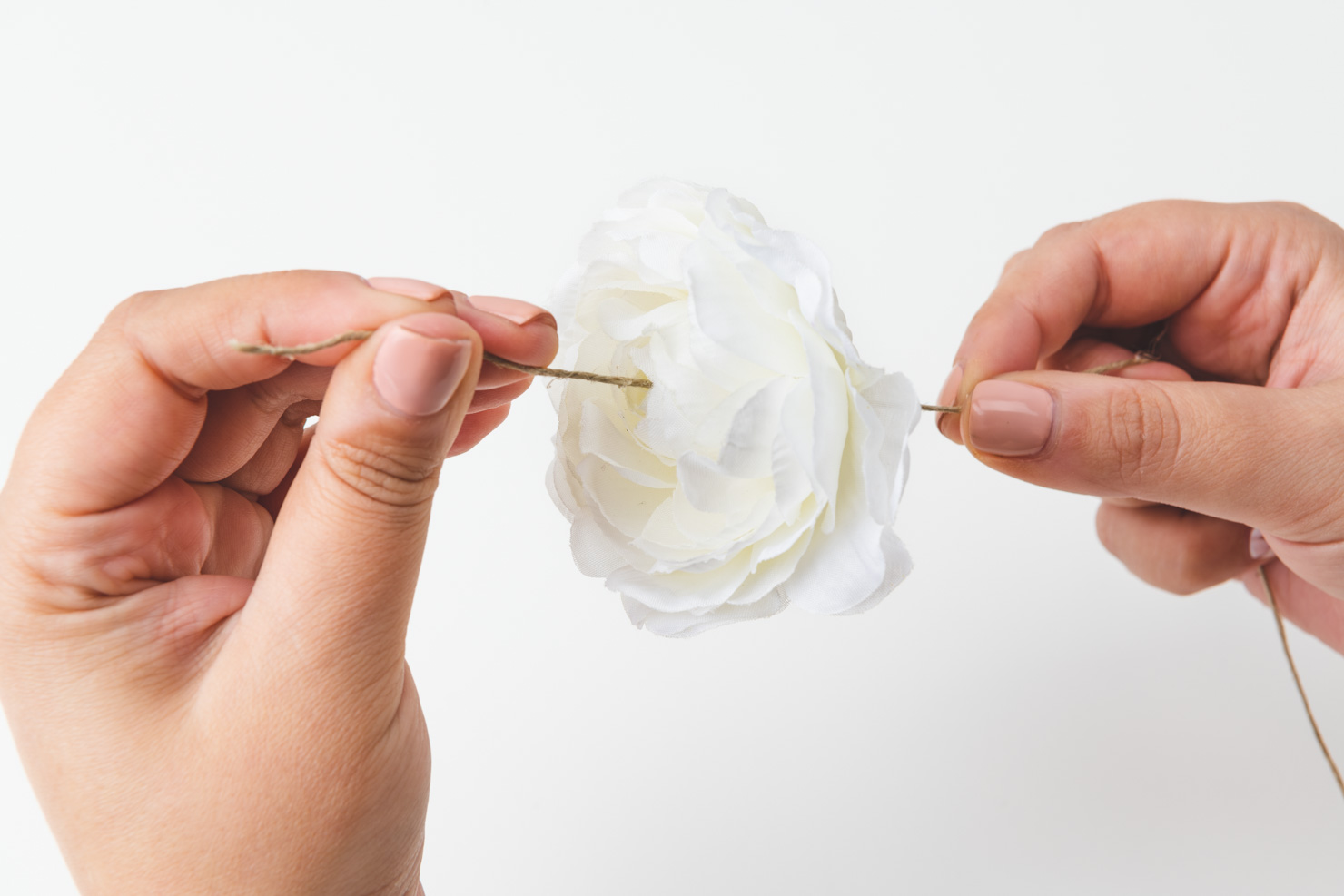 twine being strung through a flower