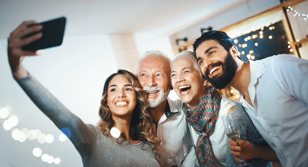 family takes a selfie at their family reunion.