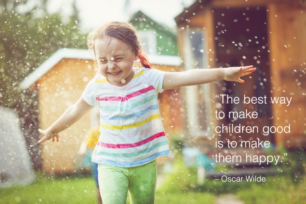 Cute child playing with garden sprinkler with children quotes overlay