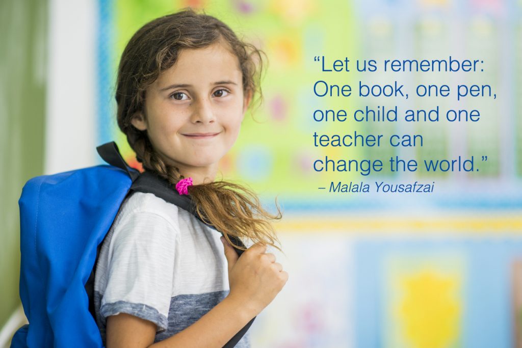 Elementary school girl is indoors in a classroom with school quotes overlay.