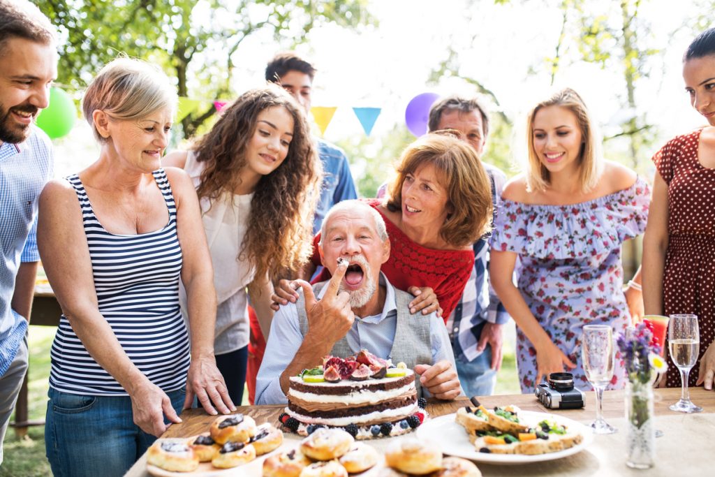 Family celebration outside in the backyard. Big garden party for a birthday.