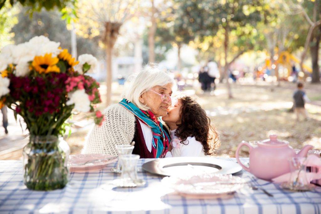 Grandkid and grandmother at tea party.