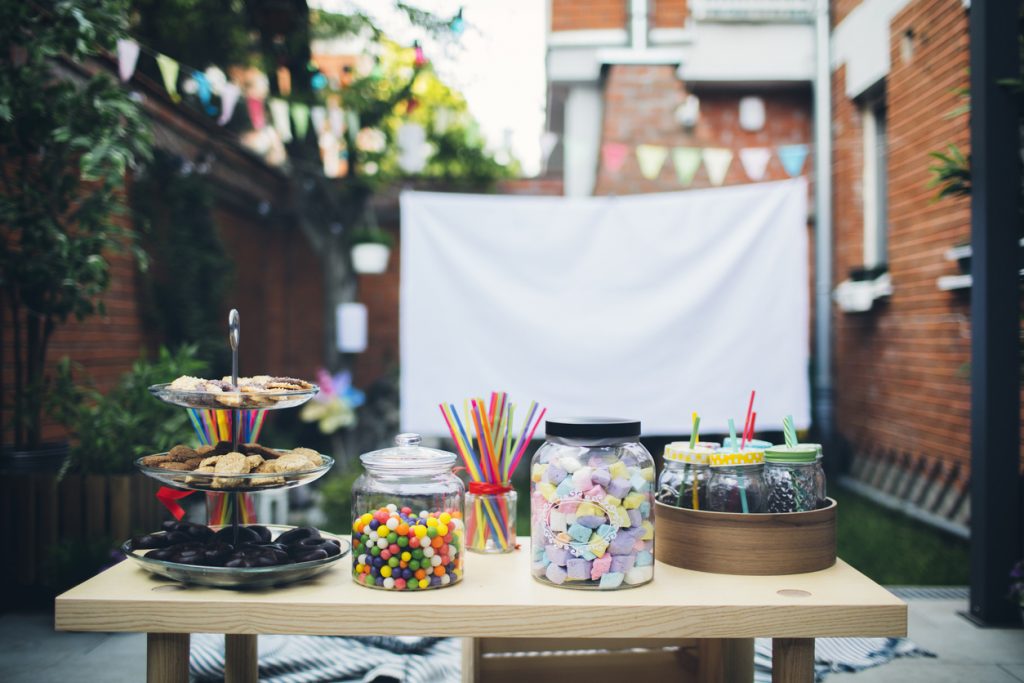 Movie screen and candy set up for birthday party.