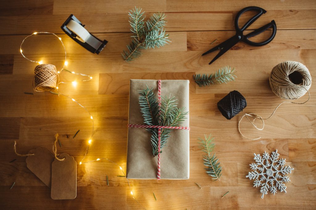 High Angle View Of Christmas Presents On Wooden Table.
