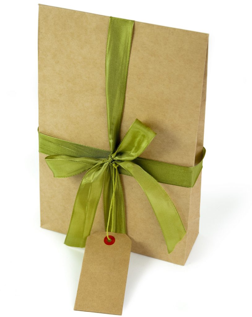 Gift bag with tag on white.