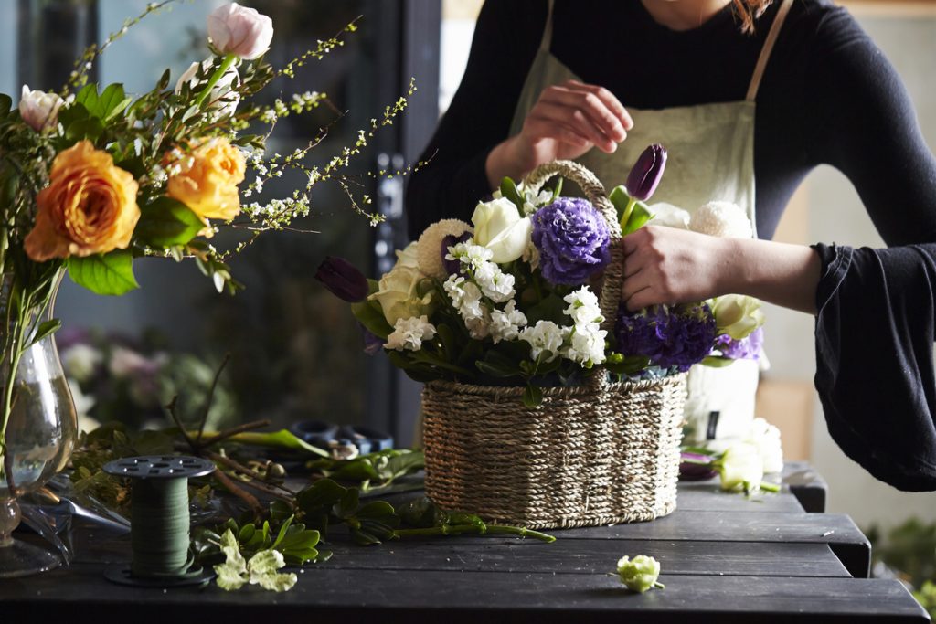 Woman doing flower arrangement.