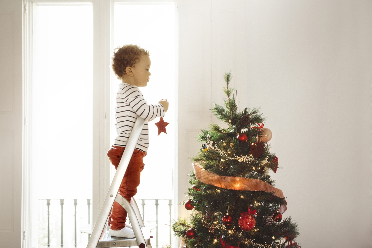 Boy decorating Christmas tree