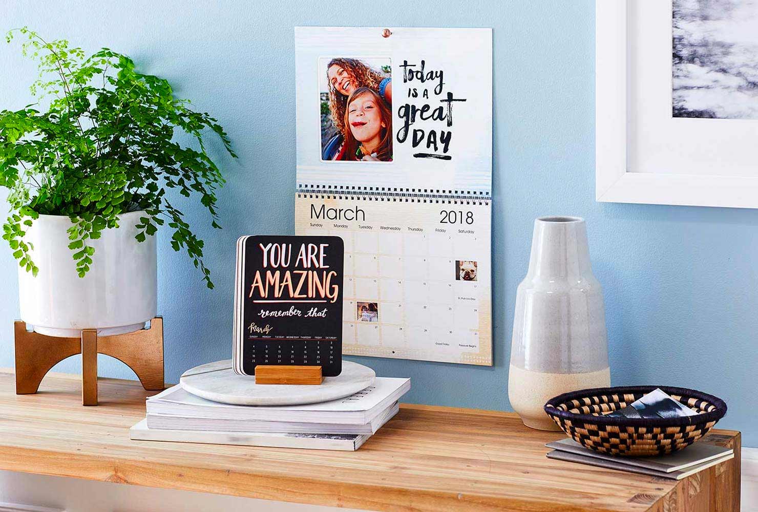 Wall calendar next to plant.