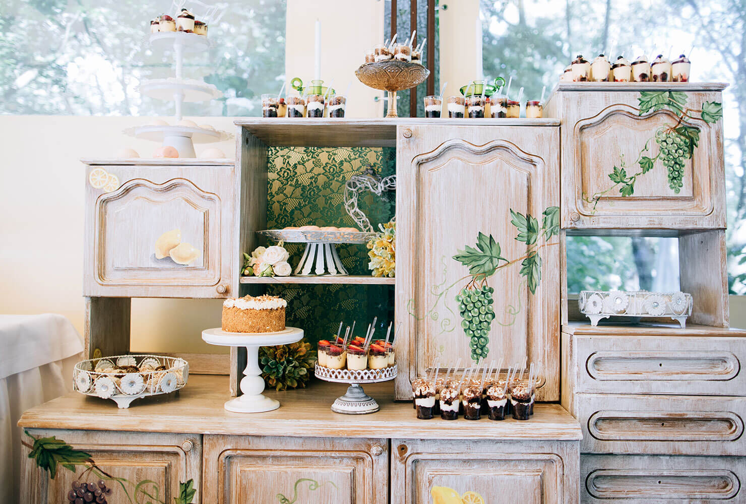 Rustic dessert station on old wooden kitchen cabinets.