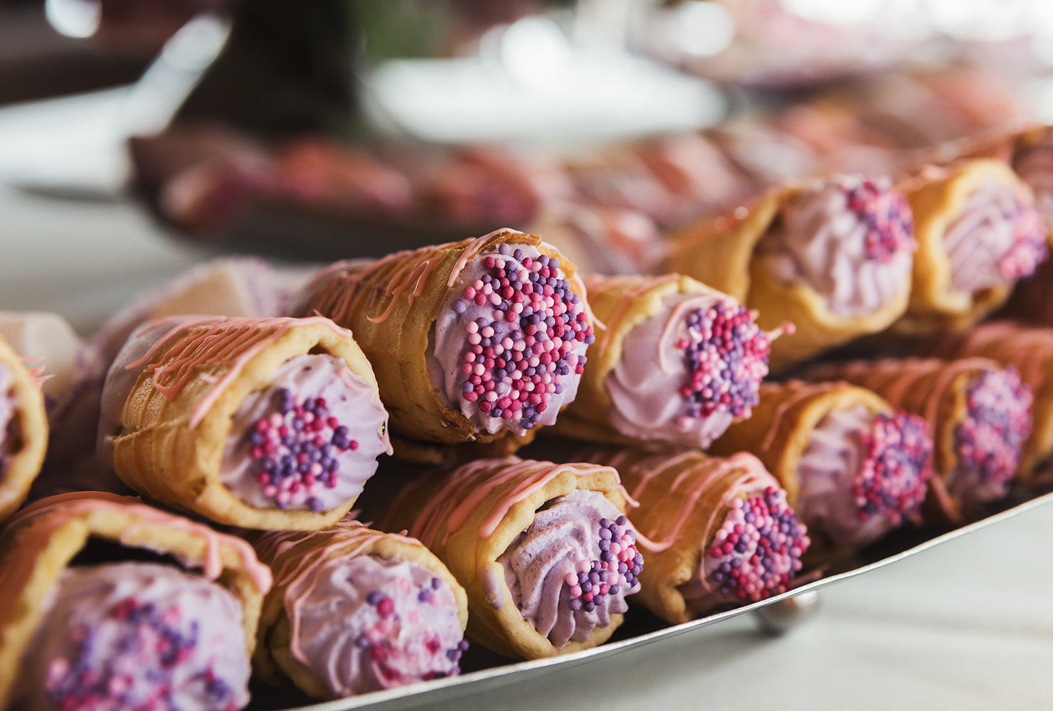 Plate of mini mousses in waffle cones.