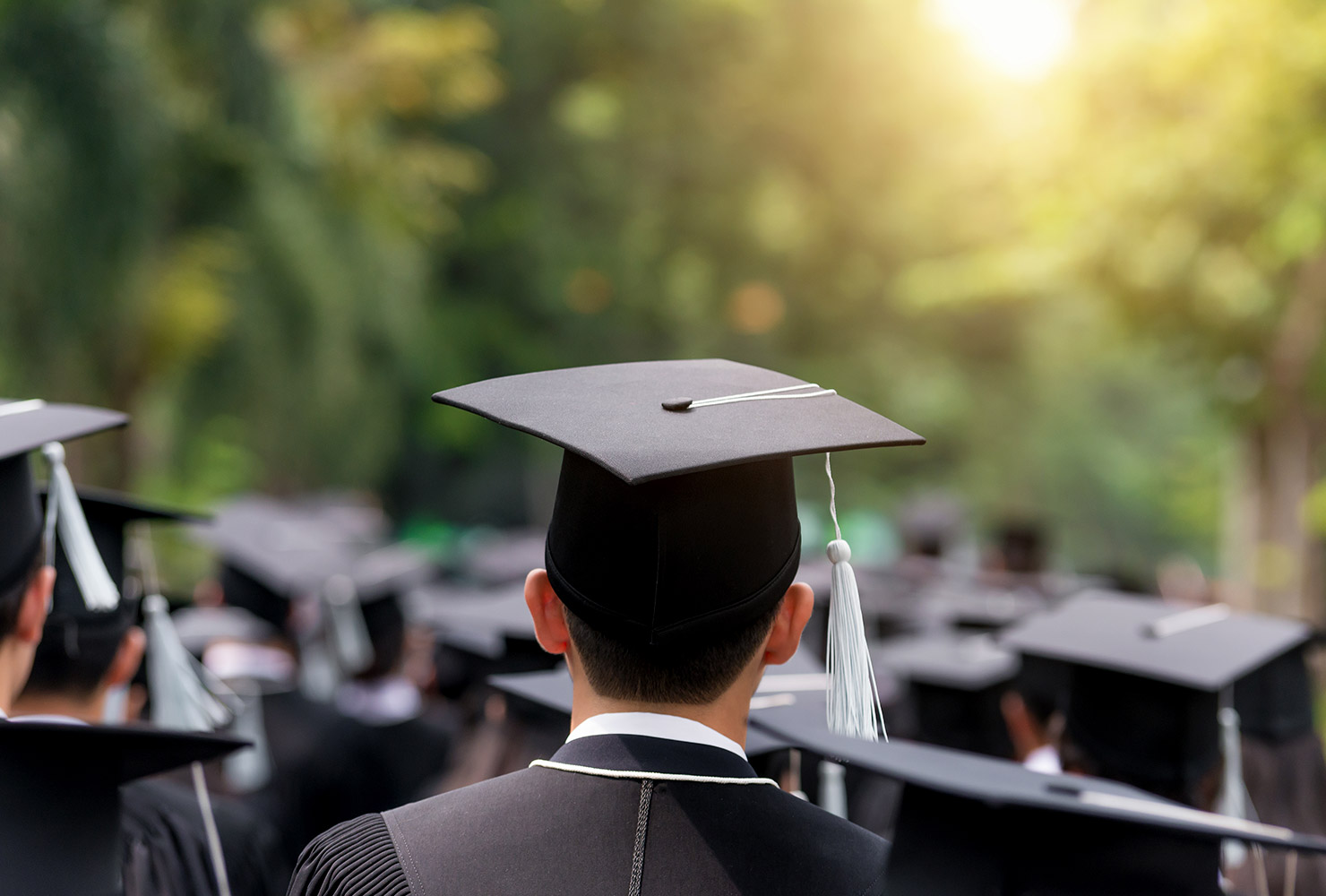 Graduates walking outside with caps on 