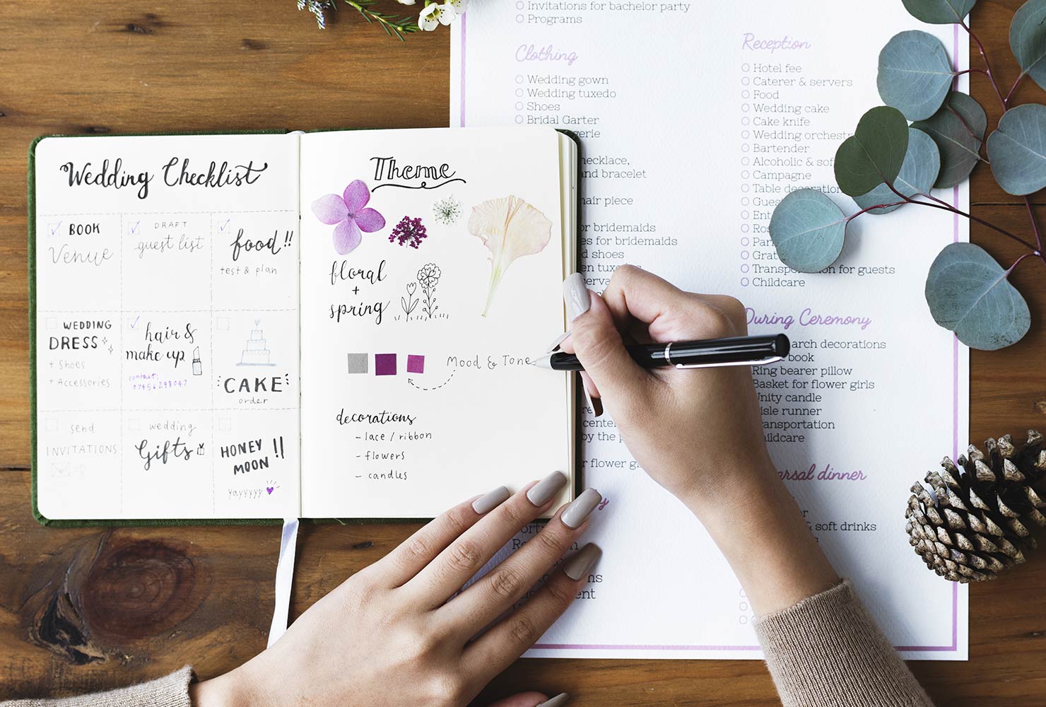 Woman writing in wedding planner.