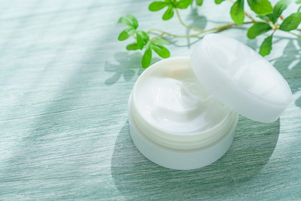 White beauty cream/hand lotion on wooden background.