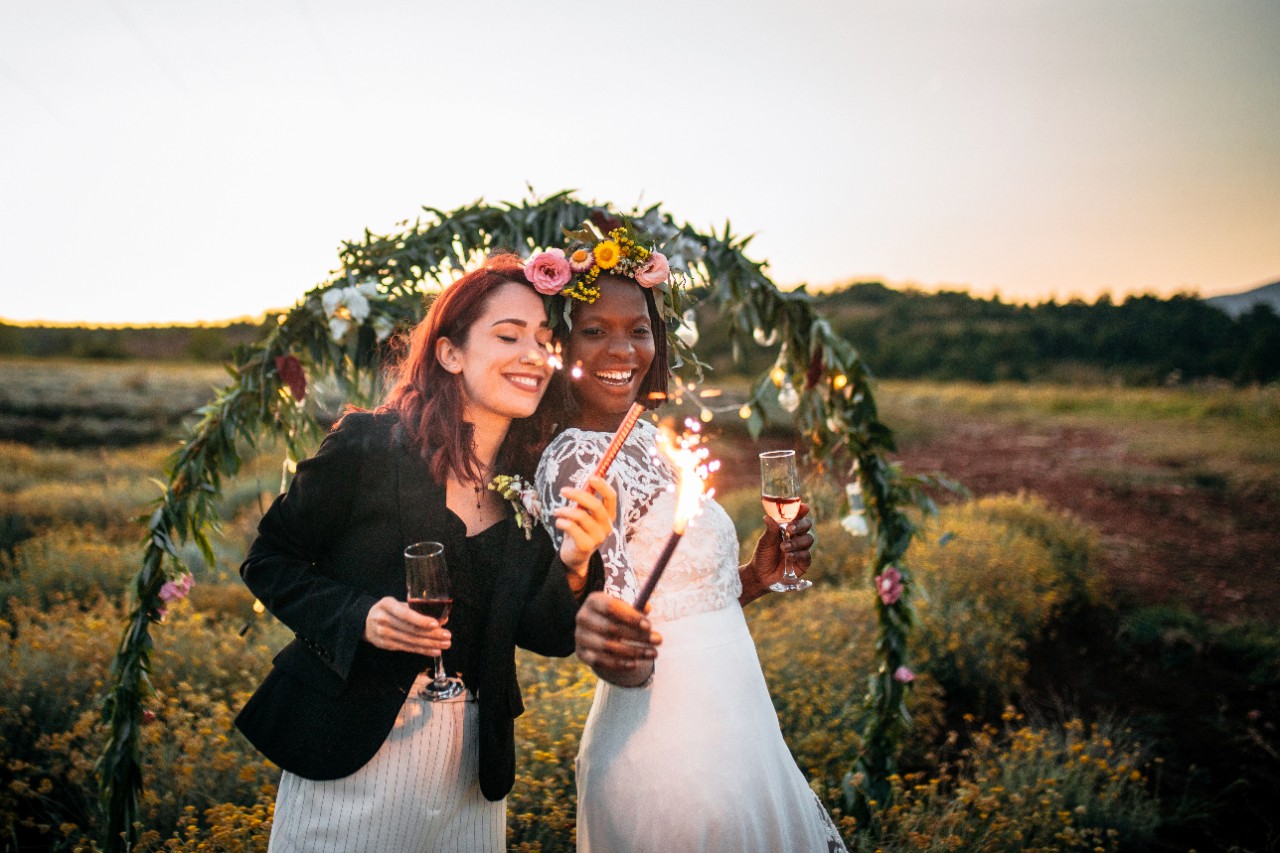 wedding couple with floral backdrop