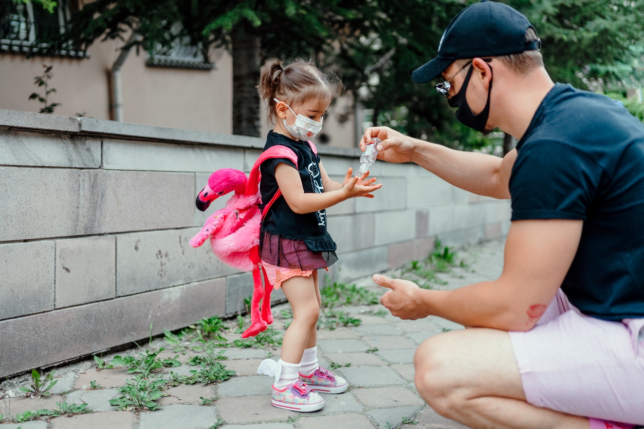 Father and daughter using w ash hand sanitizer gel